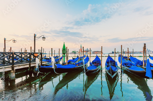 Gondolas and San Giorgio Maggiore church from San Marco square at sunrise, Venice, Italy