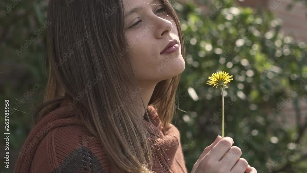 Beautiful Young Woman Holding a Yellow Flower Beautiful Young Woman Holding a Yellow Flower