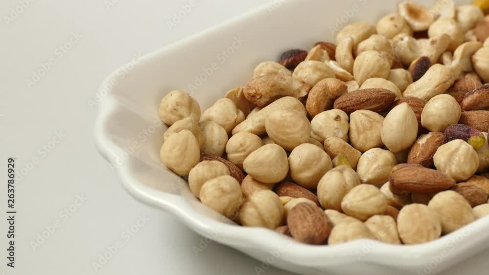 nuts, cashew nuts, dry almonds all on a plate close up nuts, cashew nuts, dry almonds all on a plate close up