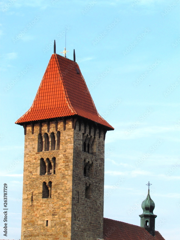 Fototapeta premium Romanesque tower of a rural church in the village of Chrenovice, vertical shot, ancient building