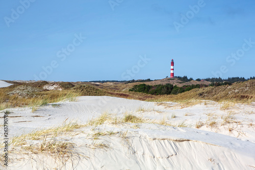 Red and white lighthouse on the hill