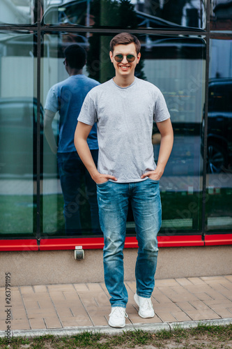 A stylish man in a gray T-shirt. Street photo