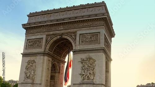 Hyperlapse at sunset around the Arc de Triomphe with tourists. Arch of triumph at the western end of the Champs Elysees and at the center of Place Charles de Gaulle photo