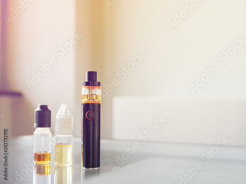 E-cigarette for vaping. Popular vape device with liquids. No smoking. Change habit of smoking. Concept for more healthy life. Electronic cigarette on hand.