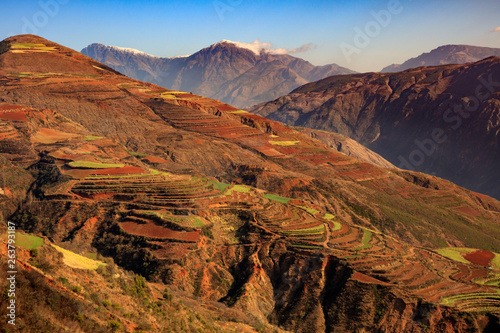 Dongchuan Red Soil, Colored Earth Terraces - Red Soil, Green Grass, Layered Terraces in Yunnan Province, China. Chinese Countryside, Agriculture, Exotic Unique Landscape. Farmland, Agriculture photo