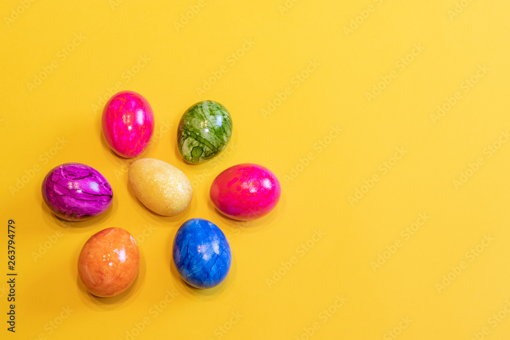 Eight colored Easter eggs on a yellow background. Top view. Happy Easter card with free, empty space. Minimal Easter concept. Eight colored Easter eggs on a yellow background. Top view. Happy Easter card with free, empty space. Minimal Easter concept.