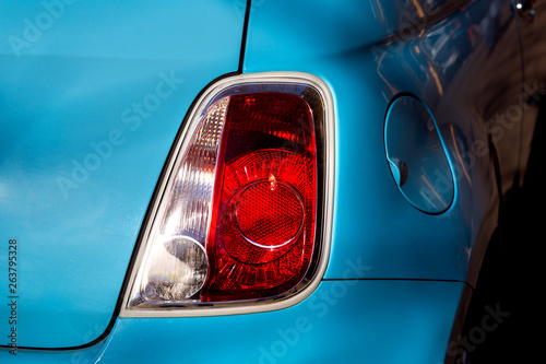 Taillight brake light of a classic retro car in blue closeup of the back of the car. © Александр Беспалый