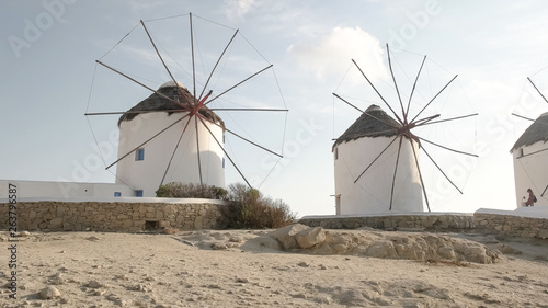 panning shot of the historic windmills on mykonos, greece