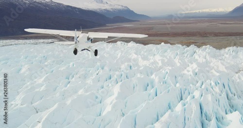 Alaska plane soars over glacier, aerial
