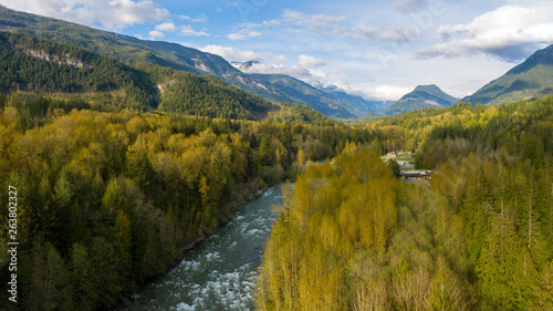 Aerial view of the panorama at the point where the Slesse creek flows into the Chilliwack river with the Welch Peak in the background