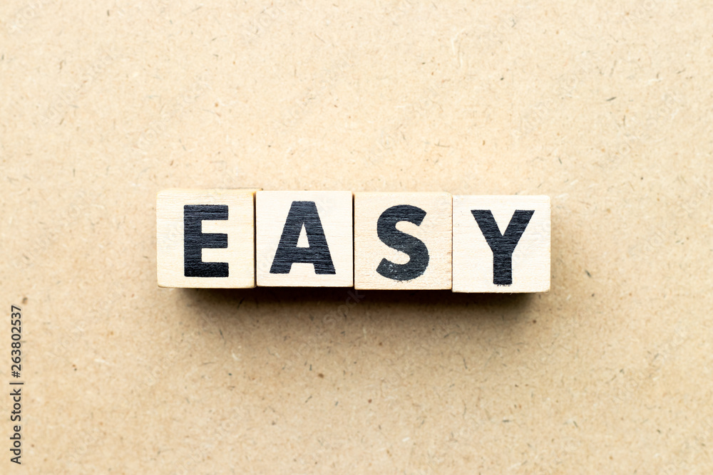 Obraz premium Alphabet letter block in word easy on wood background