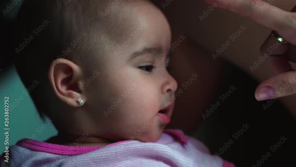 Mother kindly playing to touch her baby girl daughter's nose Mother kindly playing to touch her baby girl daughter's nose