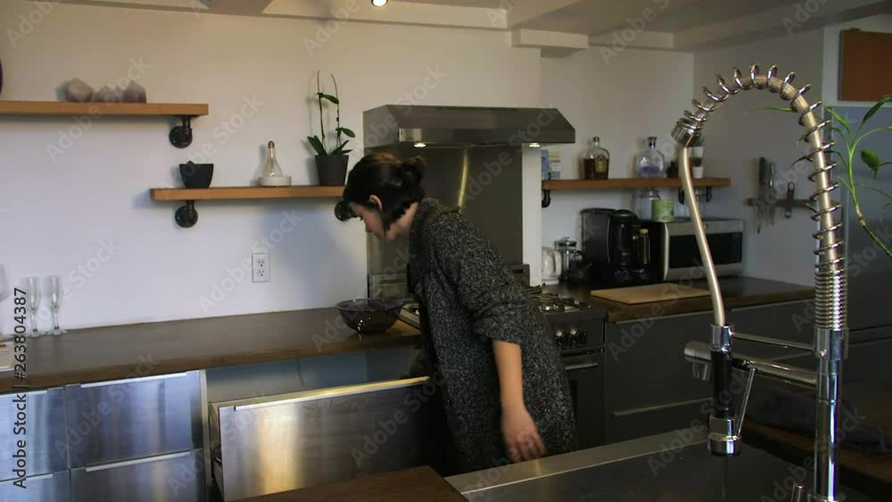A young happy woman finishes the dishes. A young happy woman finishes the dishes.