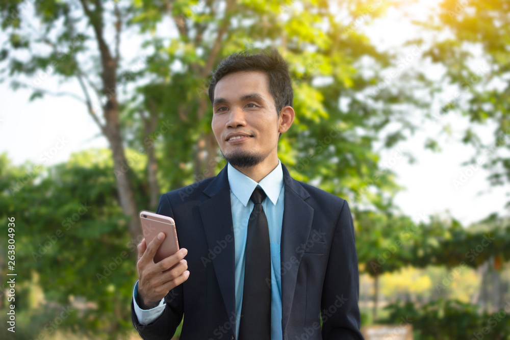 Businessman Holding Mobile Smart Phone and using Smart phone for Business connection Businessman Holding Mobile Smart Phone and using Smart phone for Business connection
