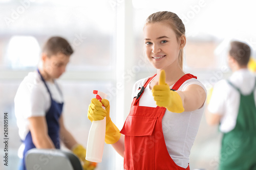 Female janitor showing thum...