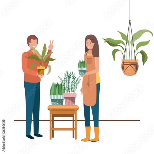 couple with houseplant on macrame hangers