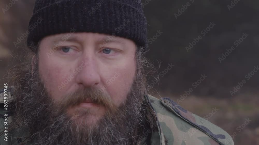 Close up of a male hunter looking and listening out for wildlife in the woods during winter, slow motion 23.98 fps. Close up of a male hunter looking and listening out for wildlife in the woods during winter, slow motion 23.98 fps.