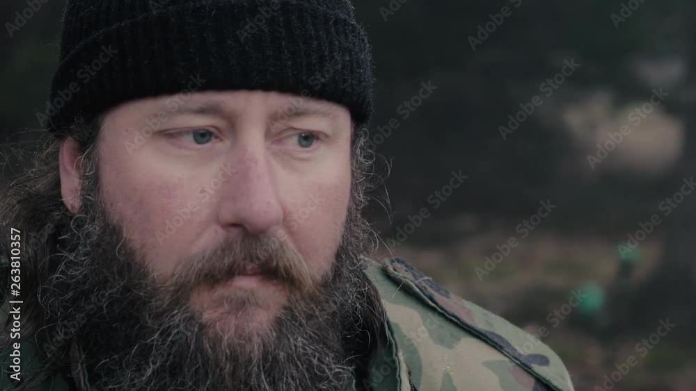 Close up of a male hunter looking and listening out for wildlife in the woods during winter, slow motion 29.97 fps. Close up of a male hunter looking and listening out for wildlife in the woods during winter, slow motion 29.97 fps.