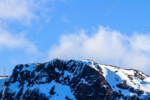 The late afternoon sun hitting the sonw covered Crater Peak in Tasmania photo