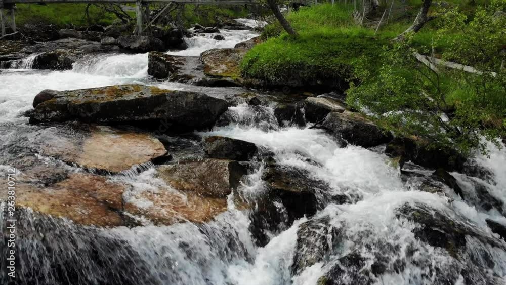 Fast flowing water river. Mountain region between Aurland and Laerdal in Norway. National tourist scenic route Aurlandsfjellet Fast flowing water river. Mountain region between Aurland and Laerdal in Norway. National tourist scenic route Aurlandsfjellet