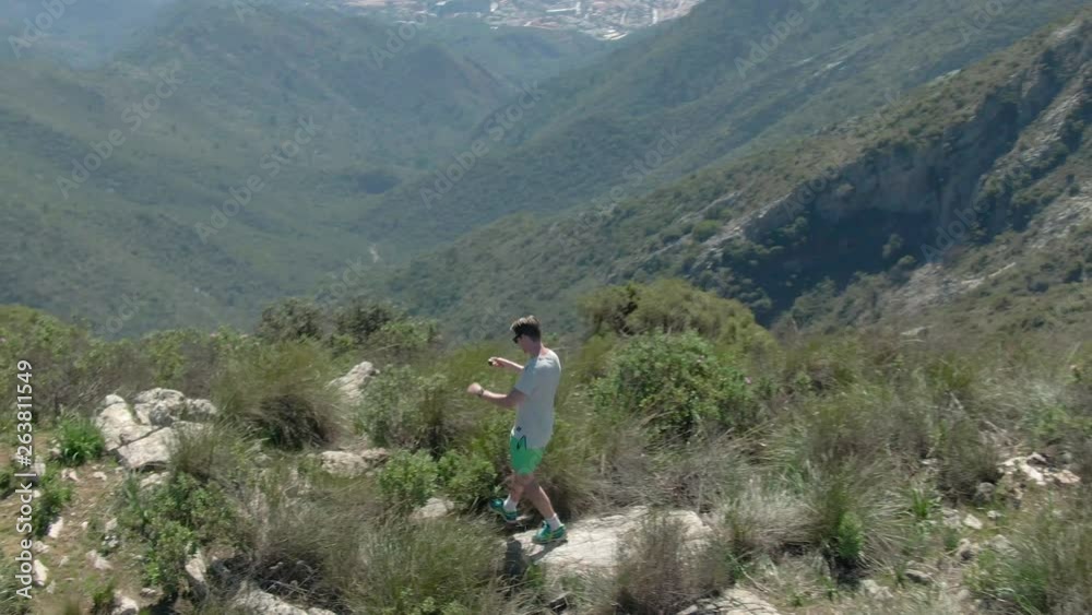 Drone tracking Scandinavian male tourist while filming the nature around La Concha in Spain. Drone tracking Scandinavian male tourist while filming the nature around La Concha in Spain.