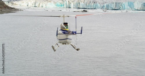 Aerial, helicopter flies over icy waters in Alaska