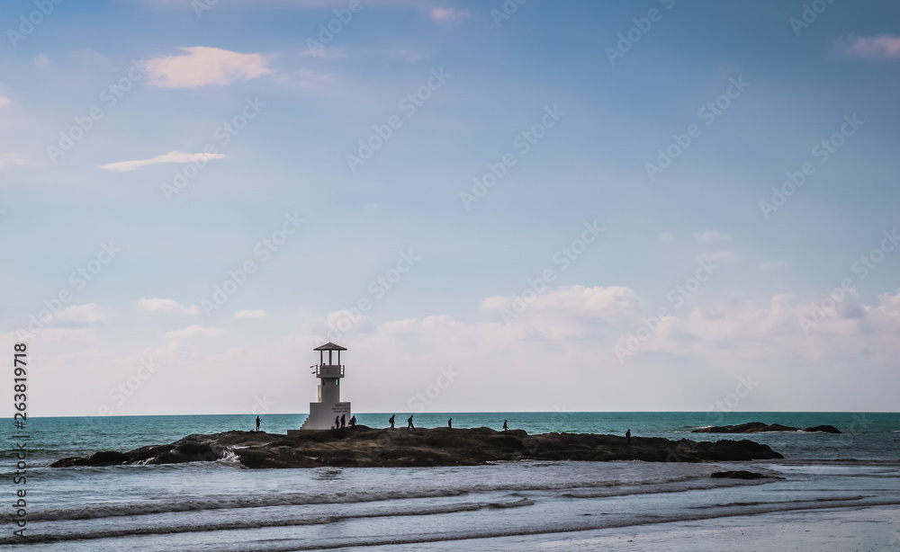 Lighthouse in the sea thailand, blue sea background with lighthouse on rock