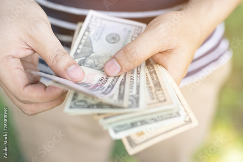 close up young man sitting hand hold Count the money spread of cash. concept finance Saving money.
