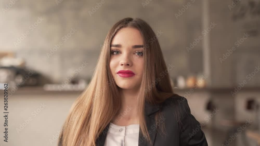 A head and shoulder close-up video of a beautiful brunette lady with baby face and stunning red lipstick on the lips. She poses and tries to make varies relaxing and flirting face expressions. A head and shoulder close-up video of a beautiful brunette lady with baby face and stunning red lipstick on the lips. She poses and tries to make varies relaxing and flirting face expressions.