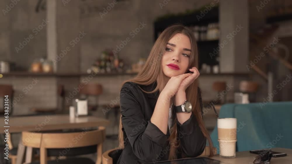 Brunette woman smiling in a cafe Brunette woman smiling in a cafe