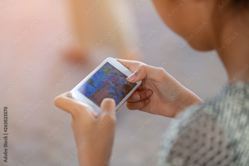 THAILAND, Rayong - April 20, 2019 girl playing Garena RoV Mobile MOBA game in park. technology, education and lifestyle concept. THAILAND, Rayong - April 20, 2019 girl playing Garena RoV Mobile MOBA game in park. technology, education and lifestyle concept.