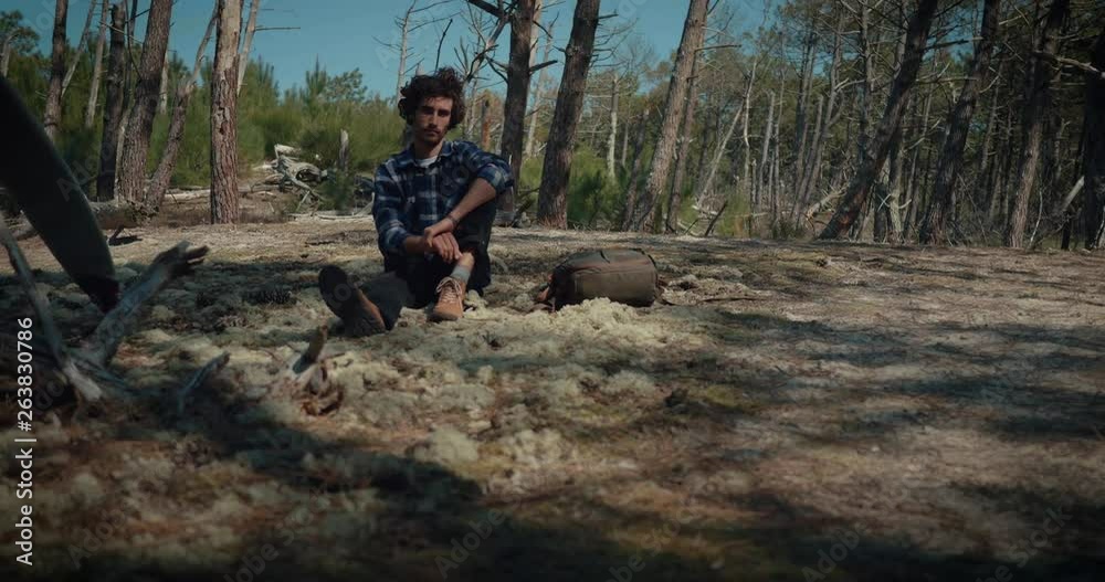 YOUNG SURFER WALKING THROUGH THE FOREST TO THE OCEAN YOUNG SURFER WALKING THROUGH THE FOREST TO THE OCEAN