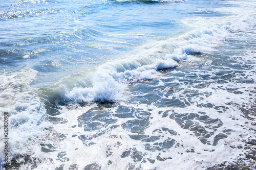 Beautiful view of splashing blue waves near the beach.
