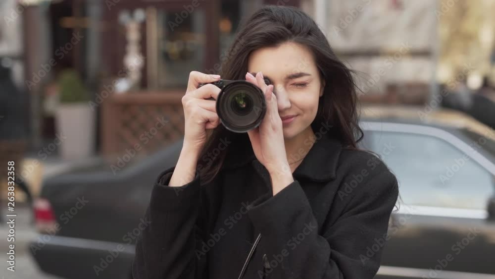 A beautiful girl with appearance like a princess.. She starts taking photos and anticipates to receive great shots. She keeps her eyes closed. The background is blurred. A beautiful girl with appearance like a princess.. She starts taking photos and anticipates to receive great shots. She keeps her eyes closed. The background is blurred.