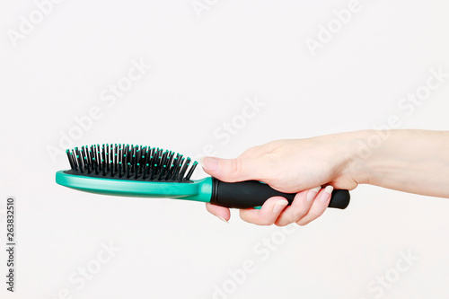 Woman holding hairbrush.
