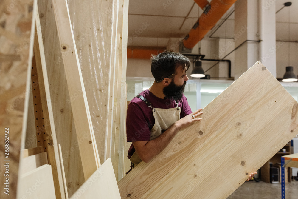 Man looking at wood in shop Man looking at wood in shop