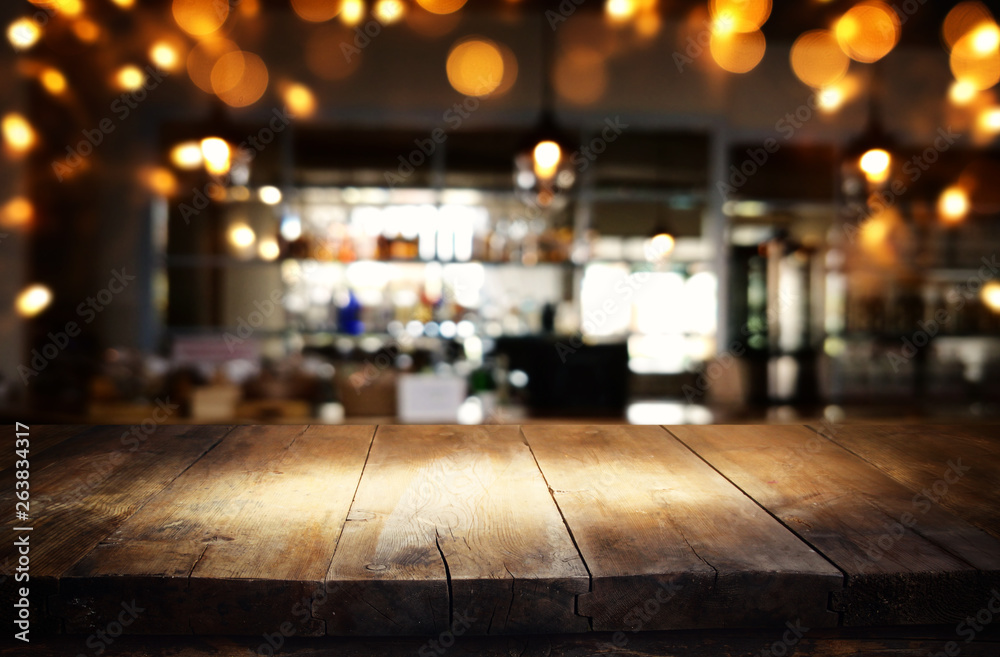 mage of wooden table in front of abstract blurred restaurant lights background mage of wooden table in front of abstract blurred restaurant lights background