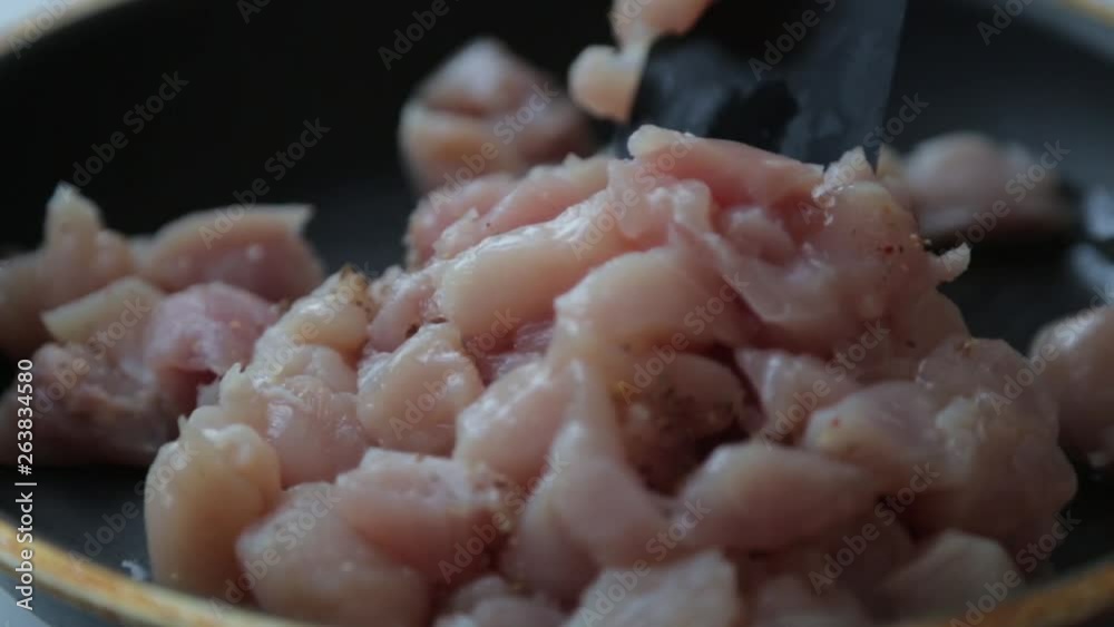 Chicken cut into cubes for cooking. Chicken fillet in a frying pan with butter. Chicken cut into cubes for cooking. Chicken fillet in a frying pan with butter.