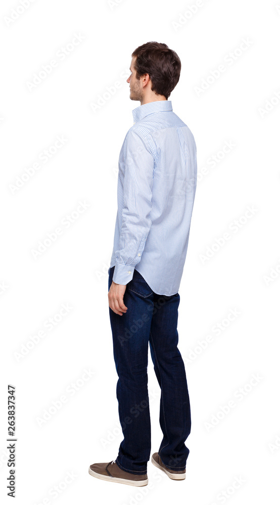 Back view of man in dark jeans. Standing young guy. Back view of man in dark jeans. Standing young guy.