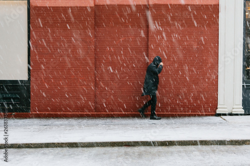Person walking through snowstorm photo