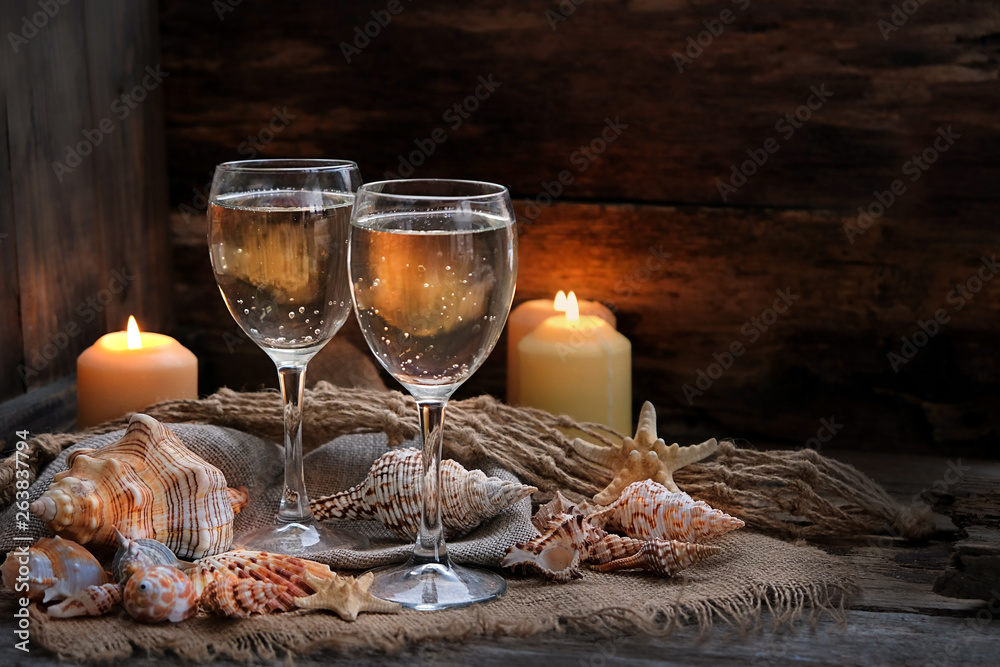 beautiful composition on sea vacation theme, Romantic beach evening. wine glasses, candles and sea decorations for serving festive table. Summer concept. soft focus