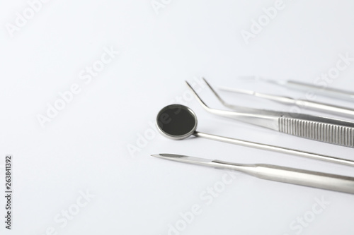 Set of different dentist tools on white background  closeup. Space for text