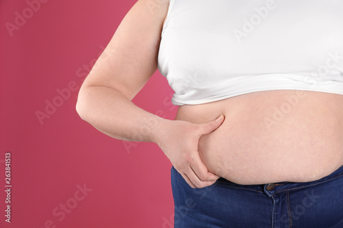 Overweight woman on color background, closeup. Space for text