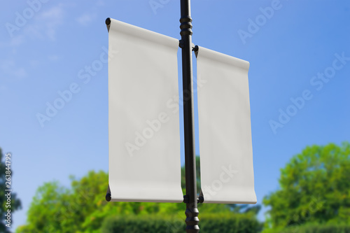 3D rendering of blank flag banner (empty advertisement) with clouds. Empty mockup template