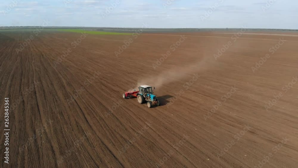 View from height of tractor in field rolls wheat crops. Agronomic activities in spring View from height of tractor in field rolls wheat crops. Agronomic activities in spring