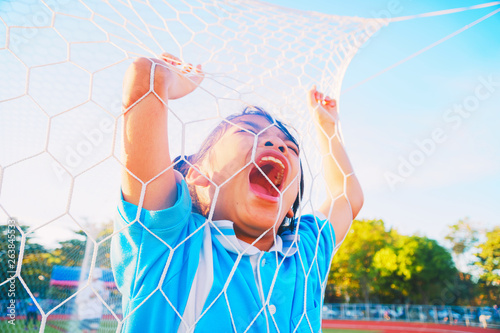 фотографія Close-up Asian little girl who caught the eye of the white screaming fiercely on the football field, The little girl is in anger