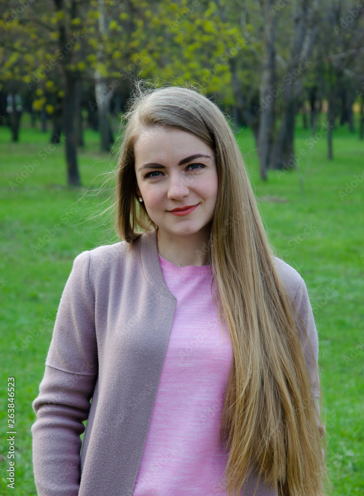 Portrait of a beautiful girl in bright pink clothes on a warm afternoon in the park Portrait of a beautiful girl in bright pink clothes on a warm afternoon in the park