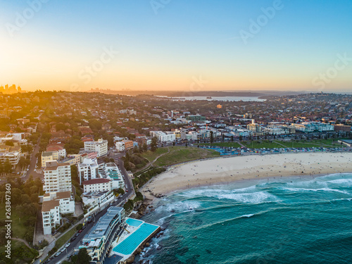 Panoramic Bondi Beach Drone Shot at Sunset with Sydney CBD in background at Sunset