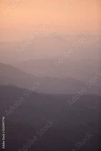 Beautiful sunset with mountains and valleys in different shades of red and orange in Tuscany  Italy