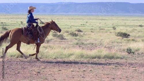Rancher riding through plains of West Texas hair blowing in the wind, Slow Motion Tracking Shot